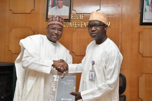 LEFT TO RIGHT: Director General Securities and Exchange Commission (SEC) Mounir  Gwarzo presenting a copy of the Ten-Year Capital Market Master Plan to Director General Federal Radio Corporation of Nigeria (FRCN) Dr. Mansur Liman when the Management of SEC visited FRCN in Abuja, weekend. 