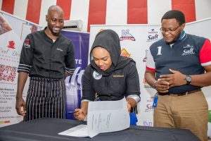 L-R: Chef Stone of Red Dish Chronicles Culinary School, Abuja; Mrs. Fatima Mustapha (Mother of Chef Zeeliciousss); Head Marketing, NASCON Allied Industries Limited, Olufemi Ashipa; Ms. Zara Mustapha (Chef Zeeliciousss) Brand Ambassador NASCON Allied Industries Limited; Mr. Mustapha (Father of Chef Zeeliciousss) at the signing ceremony of NASCON Allied Industries Limited Brand Ambassador in Abuja