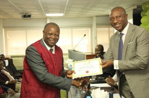  L – R shows Mr. Sola Oni, Newly Inducted Stockbroker with Mr. Oscar N. Onyema, Chief Executive Officer, OON, NSE at the Induction Ceremony for recently qualified dealing clerks at The Nigerian Stock Exchange today.