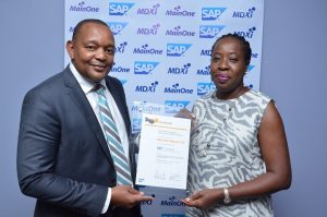 Managing Director of SAP West Africa, Kudzai Danha, presenting the SAP certification for Infrastructure Operations Services to Chief Executive Officer of MainOne, Funke Opeke, during a ceremony held at SAP’s Head Office in Nigeria on Wednesday