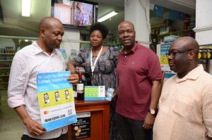 (L-R) Abraham Orji, Proprietor, Nova Food Limited (Super Shop) and Mrs. Doris Orji; Patrick Akinwuntan, Ecobank Group Executive Consumer Banking and Tunde Kuponiyi, Acting Head, Consumer Distribution, Ecobank Nigeria during the pilot testing of Ecobank MasterPass QR, the new innovative payment solution that enables buyers pay for goods with their phones by scanning a Quick Response (QR) at the merchant location