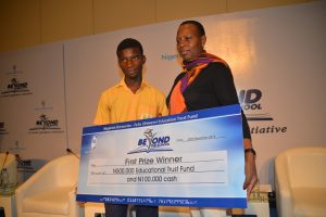 From Left to Right: Godwin Daniel; Eric Moore Senior High School (1st position) receiving his prize from Mrs. Clemetine Vervelde, Project Champion, Beyond the School Initiative at the 2016 Beyond the School Programme in Lagos on Friday.