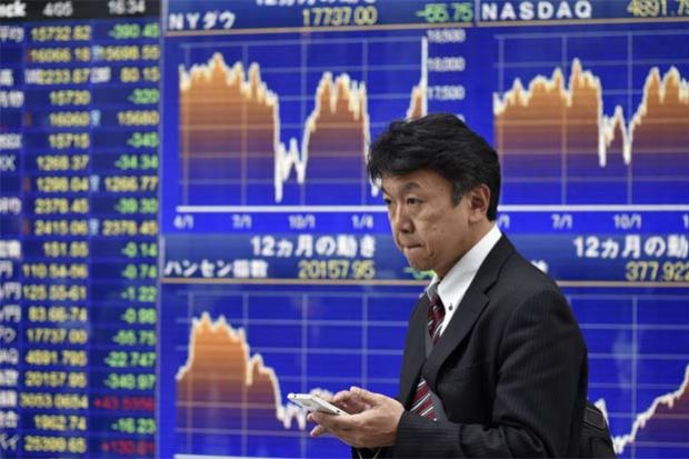 Asia shares inch down, dollar extends gains in light holiday trade